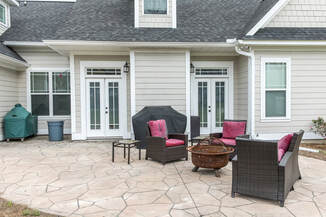 Stamped concrete patio with furnishings in front of a house in Westminster, Colorado